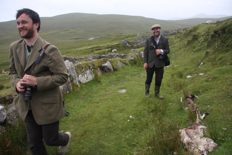It was no laughing matter for the sheep. Paul and Gentian having the craic at the deserted village on Slievemore in 2013 (Digital Photograph: Brian Mac Domhnaill, July 2013).
